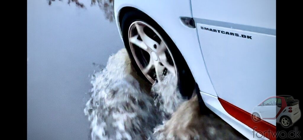 Smart Fortwo wading thru a flooded road